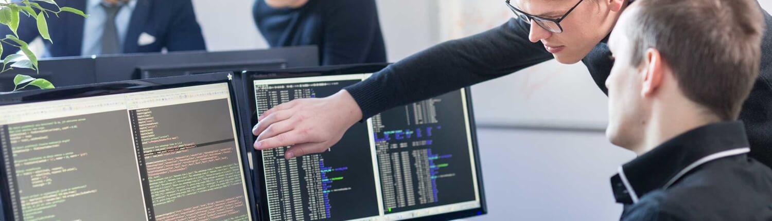 two-software-developers-working-on-a-project-with-two-monitors
